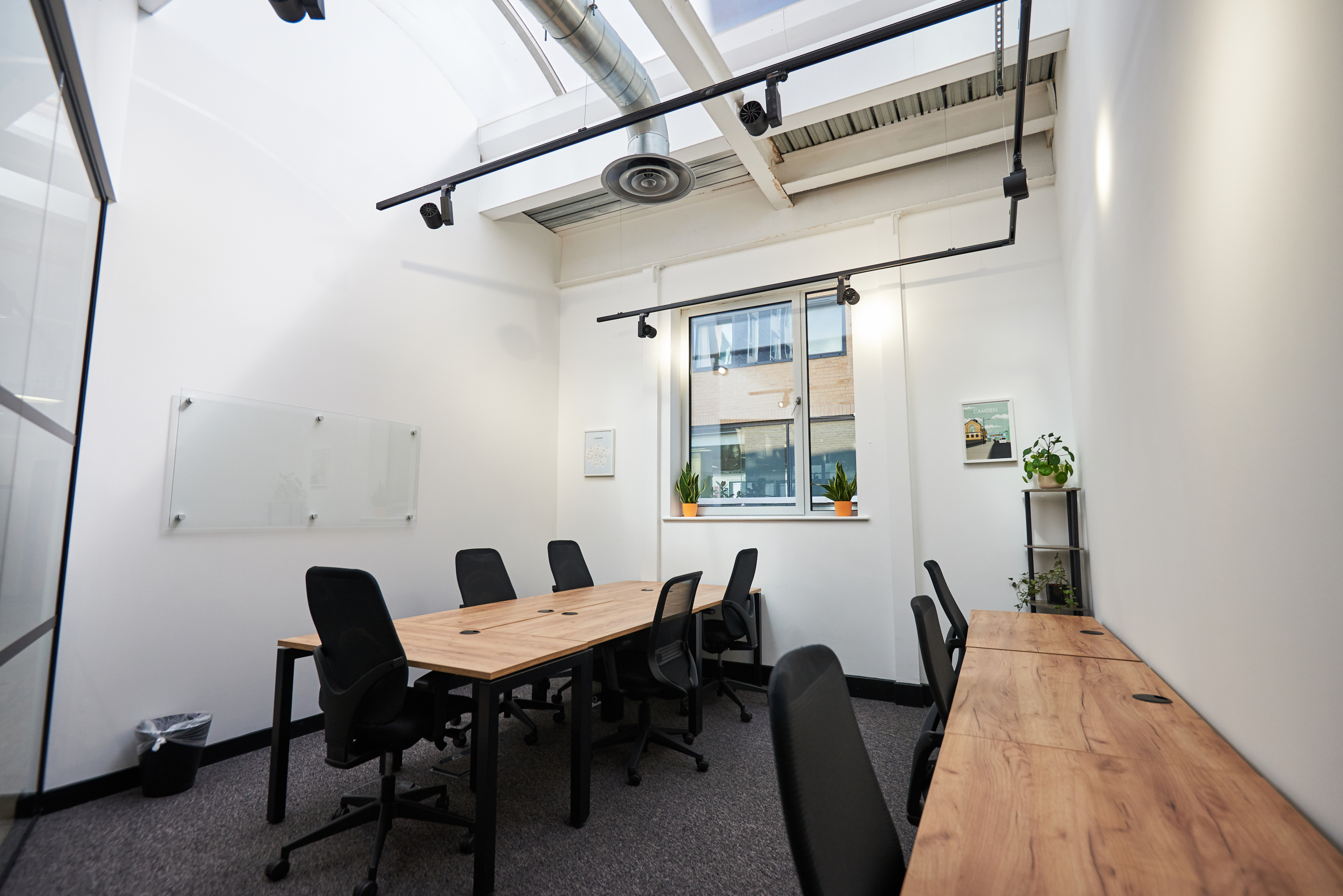 Professional meeting workspace with conference seating, presentation area and comfortable office surroundings