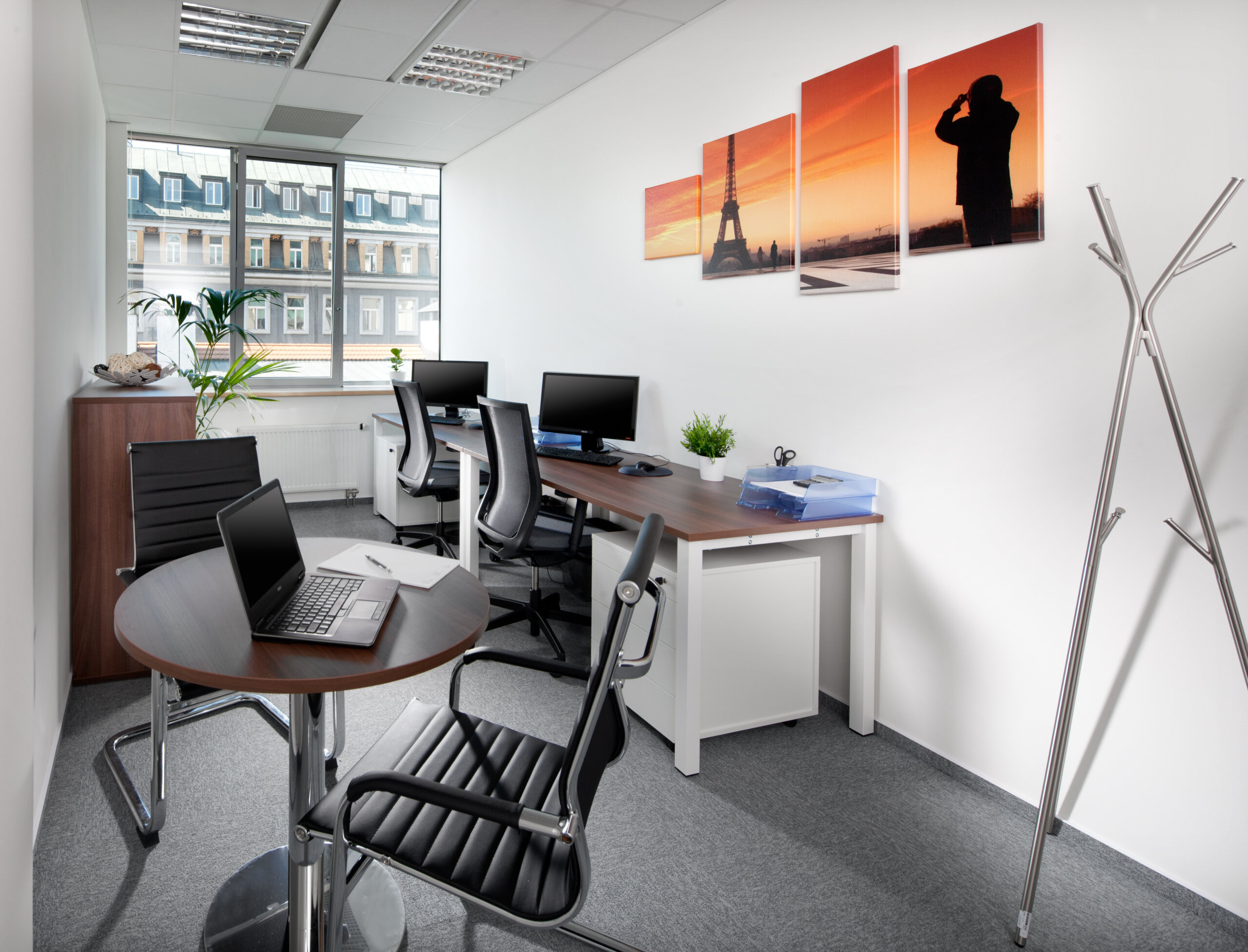 Compact private office with defined workstations, efficient circulation and a small meeting area